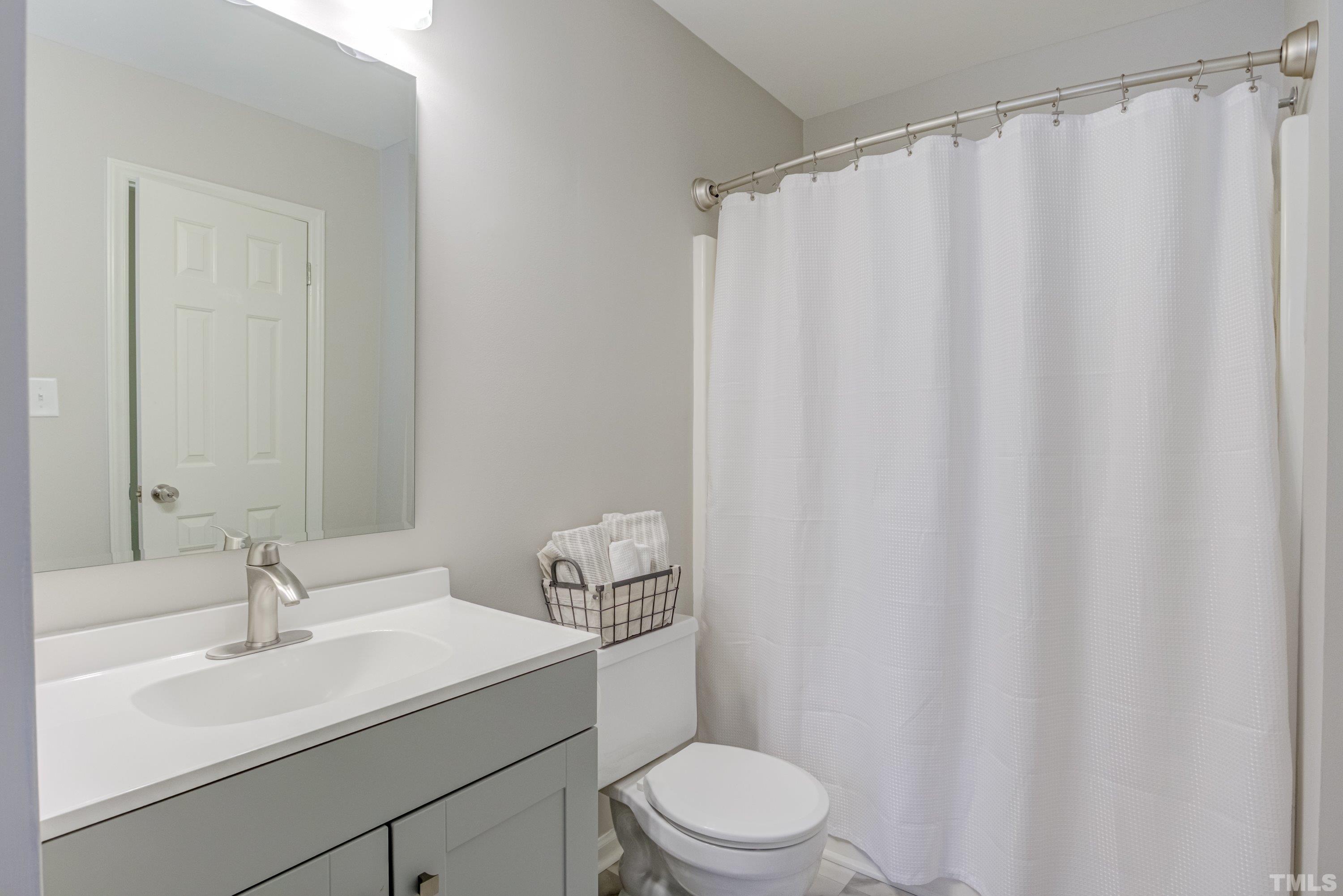 100 Wythe Circle Raleigh, NC 27615 - Photo 32 of 46 New Vanity, beveled glass mirror. Vinly - " Splendor Ivory." Brushed - Nickel Faucet.