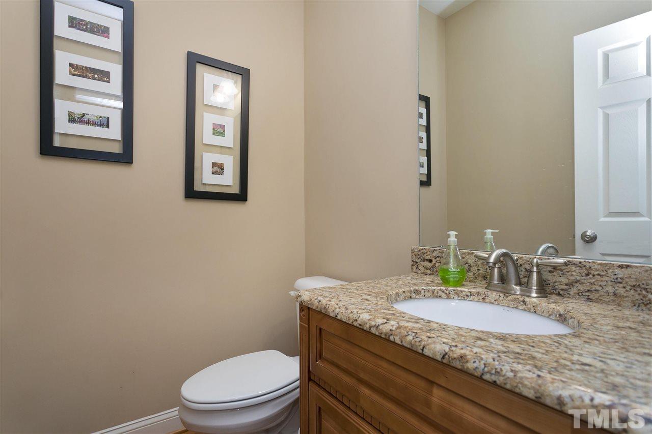 4630 Pat Reed Road Raleigh, NC 27616 - Photo 13 of 25 a bathroom with a granite countertop toilet sink and mirror