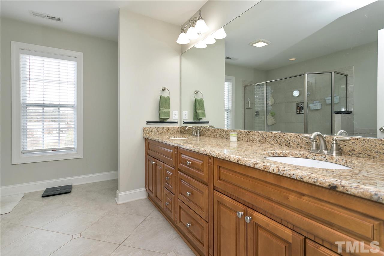 4630 Pat Reed Road Raleigh, NC 27616 - Photo 18 of 25 a bathroom with a granite countertop sink and a mirror