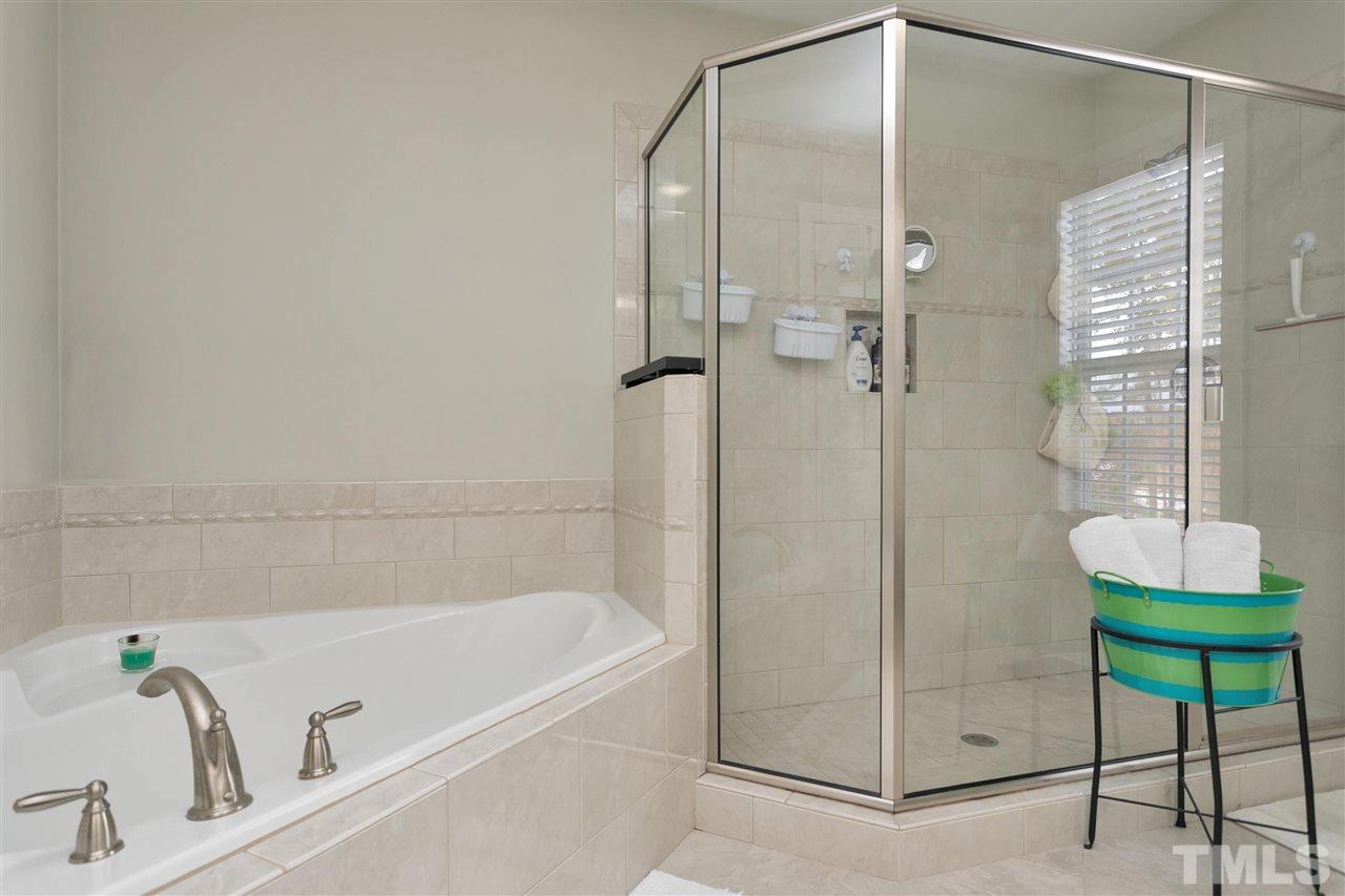 4630 Pat Reed Road Raleigh, NC 27616 - Photo 19 of 25 a bathroom with a tub and a shower
