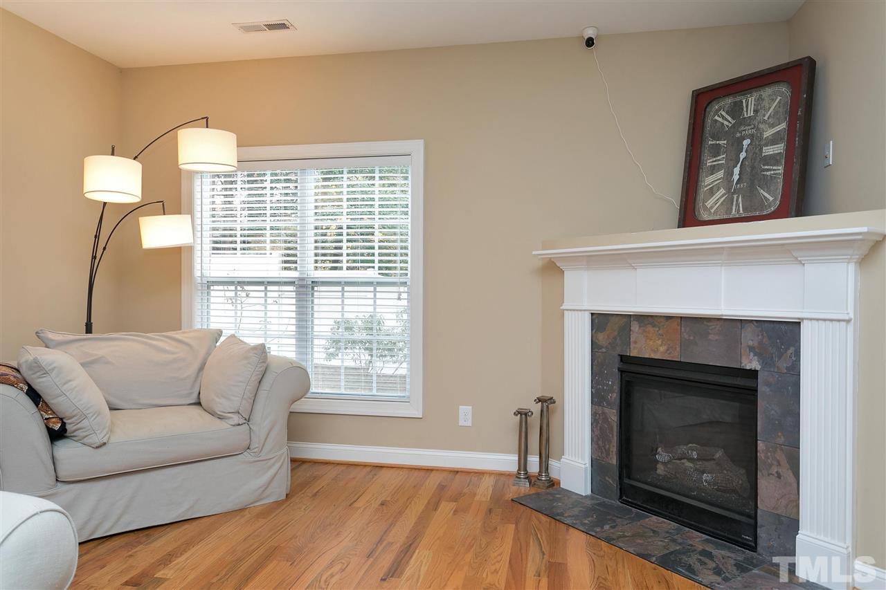 4630 Pat Reed Road Raleigh, NC 27616 - Photo 3 of 25 a living room with furniture and a fireplace