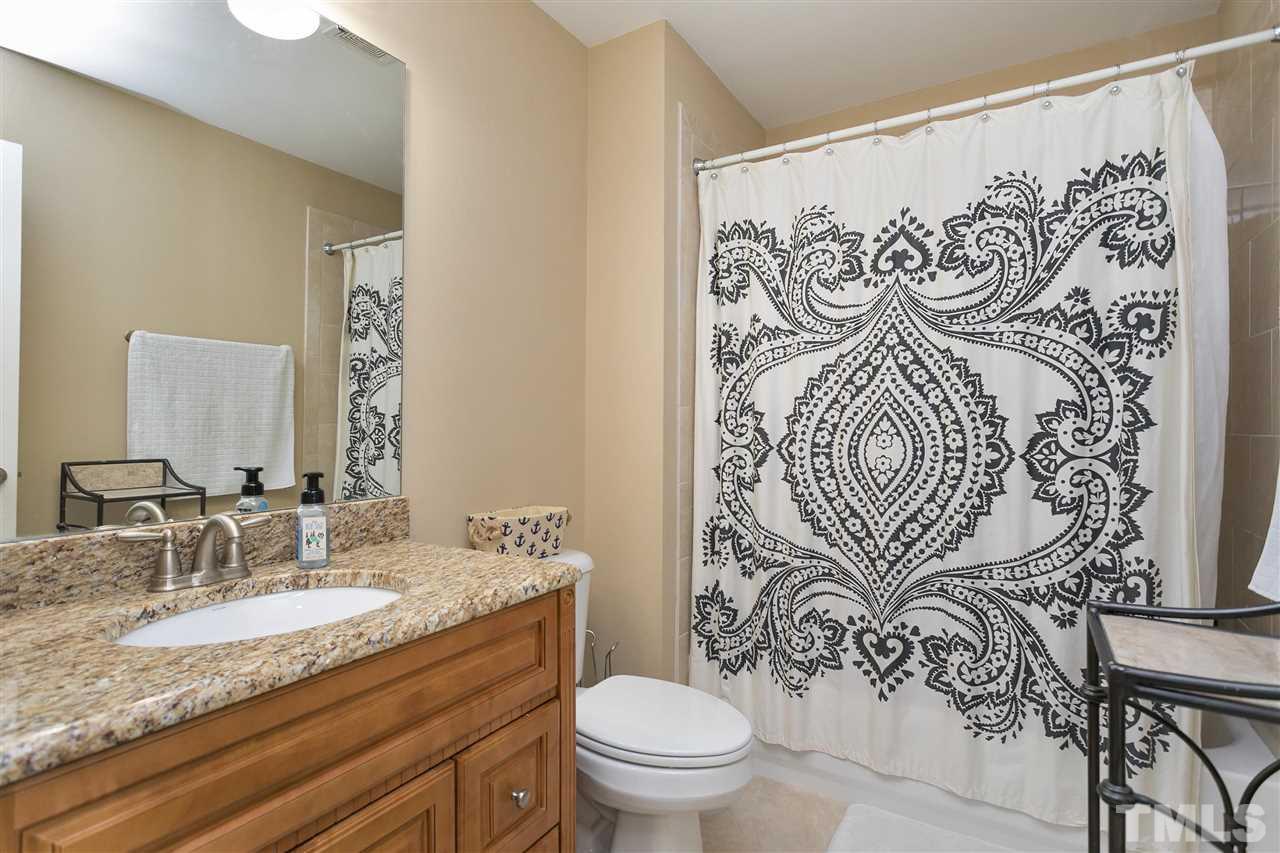 4630 Pat Reed Road Raleigh, NC 27616 - Photo 22 of 25 a bathroom with a granite countertop sink and a mirror