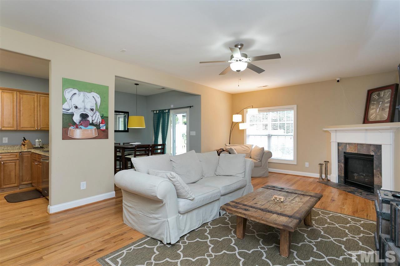 4630 Pat Reed Road Raleigh, NC 27616 - Photo 4 of 25 a living room with furniture a fireplace and a flat screen tv