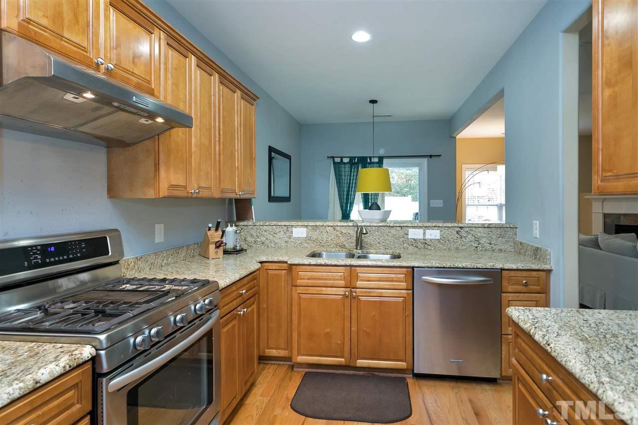4630 Pat Reed Road Raleigh, NC 27616 - Photo 10 of 25 a kitchen with stainless steel appliances granite countertop a stove a sink and a microwave
