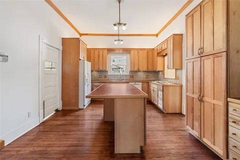 a kitchen with stainless steel appliances granite countertop a sink a stove and a refrigerator