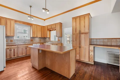 a kitchen with a stove a sink and a refrigerator