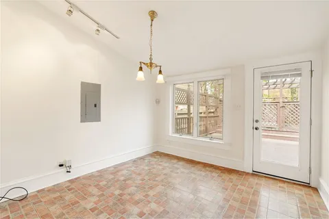 a view of a kitchen with wooden floor and a window