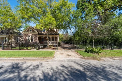 a view of backyard of house with green space