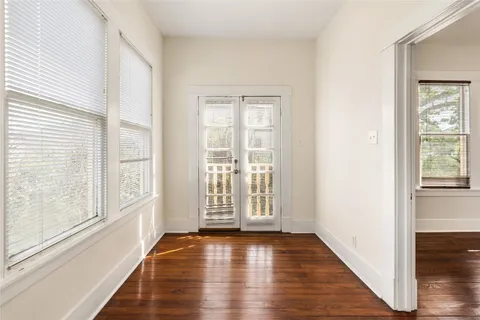 a view of a room with wooden floors and ceiling fan