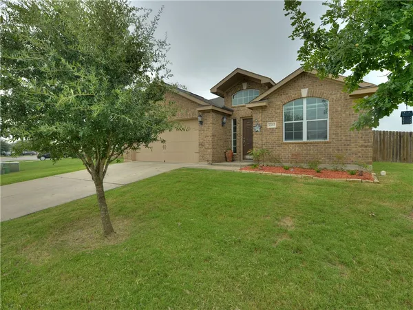 a front view of house with yard and green space