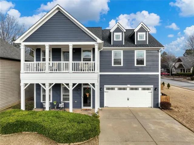 a view of a hallway with wooden floor cabinets and a living room