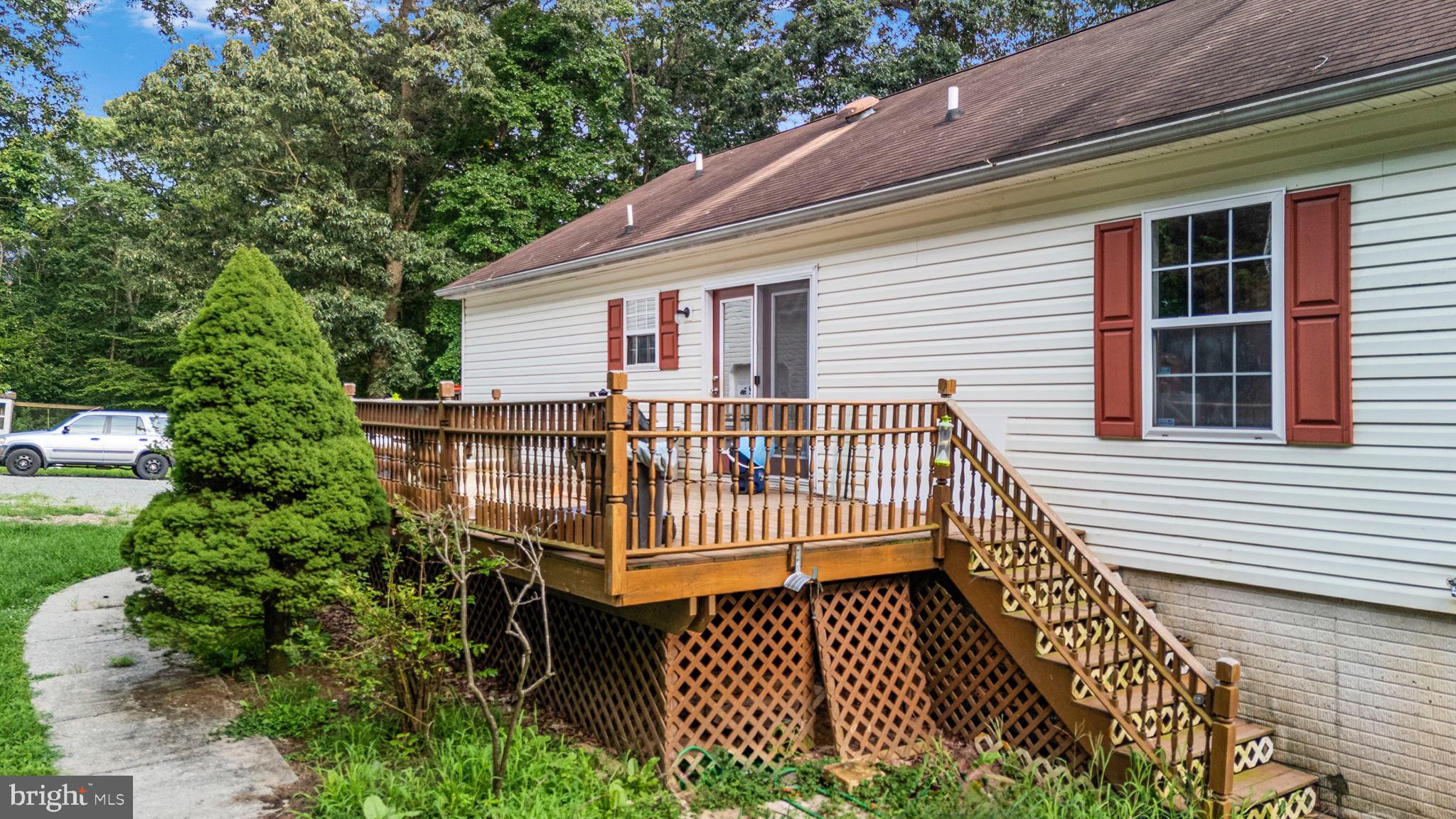 341 Goosemar Road Rising Sun, MD 21911 - Photo 2 of 24 a view of a wooden deck with a bench