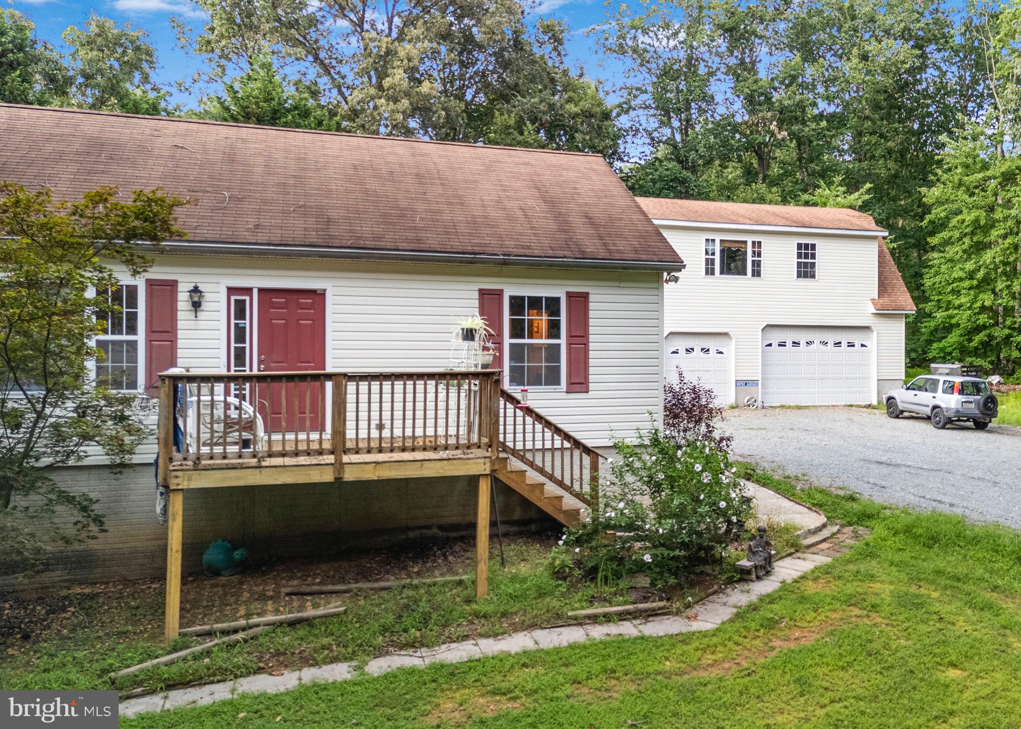 341 Goosemar Road Rising Sun, MD 21911 - Photo 4 of 24 a backyard of a house with a garden and outdoor seating