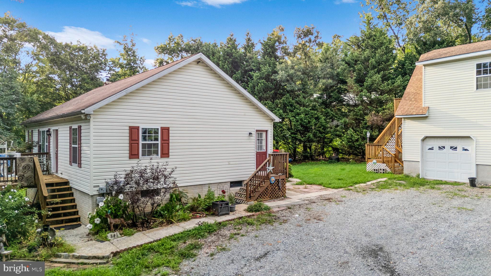 341 Goosemar Road Rising Sun, MD 21911 - Photo 5 of 24 a view of a house with a yard and a garden