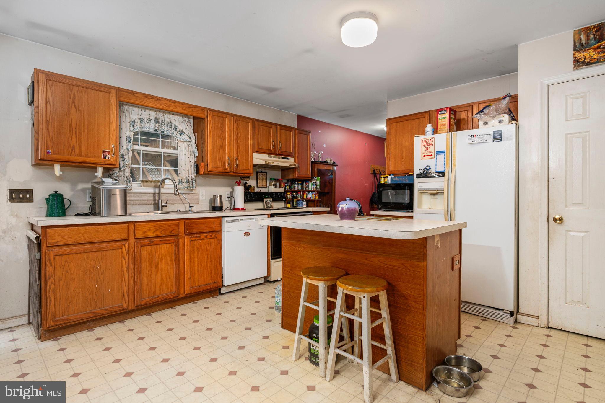 341 Goosemar Road Rising Sun, MD 21911 - Photo 7 of 24 a kitchen with stainless steel appliances granite countertop a refrigerator a sink dishwasher a stove with white cabinets and wooden floor