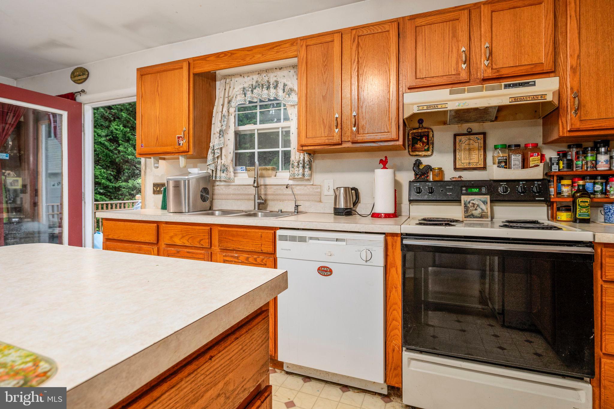 341 Goosemar Road Rising Sun, MD 21911 - Photo 10 of 24 a kitchen with stainless steel appliances granite countertop a stove a sink and a microwave