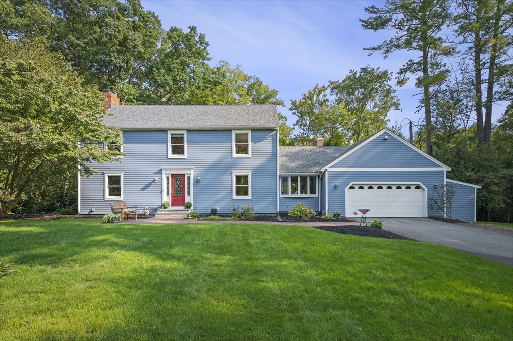 a view of a house with a big yard and large trees