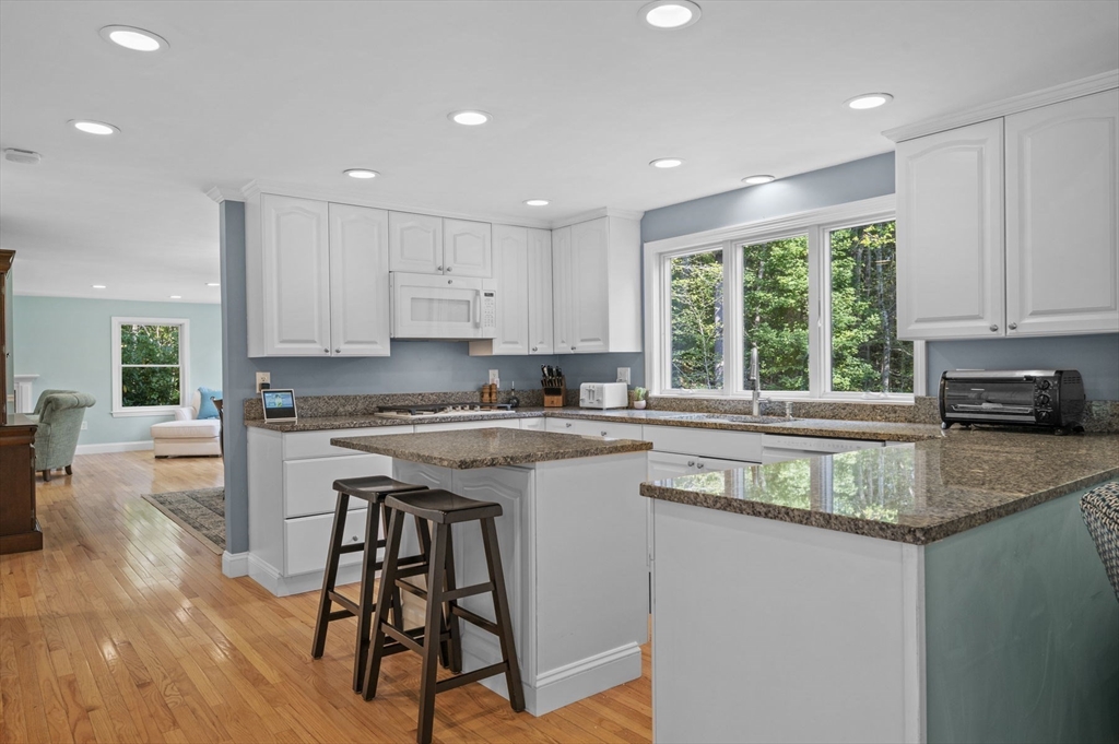 6 Beechwood Circle Boxford, MA 01921 - Photo 13 of 42 a kitchen with a stove a sink a microwave and cabinets