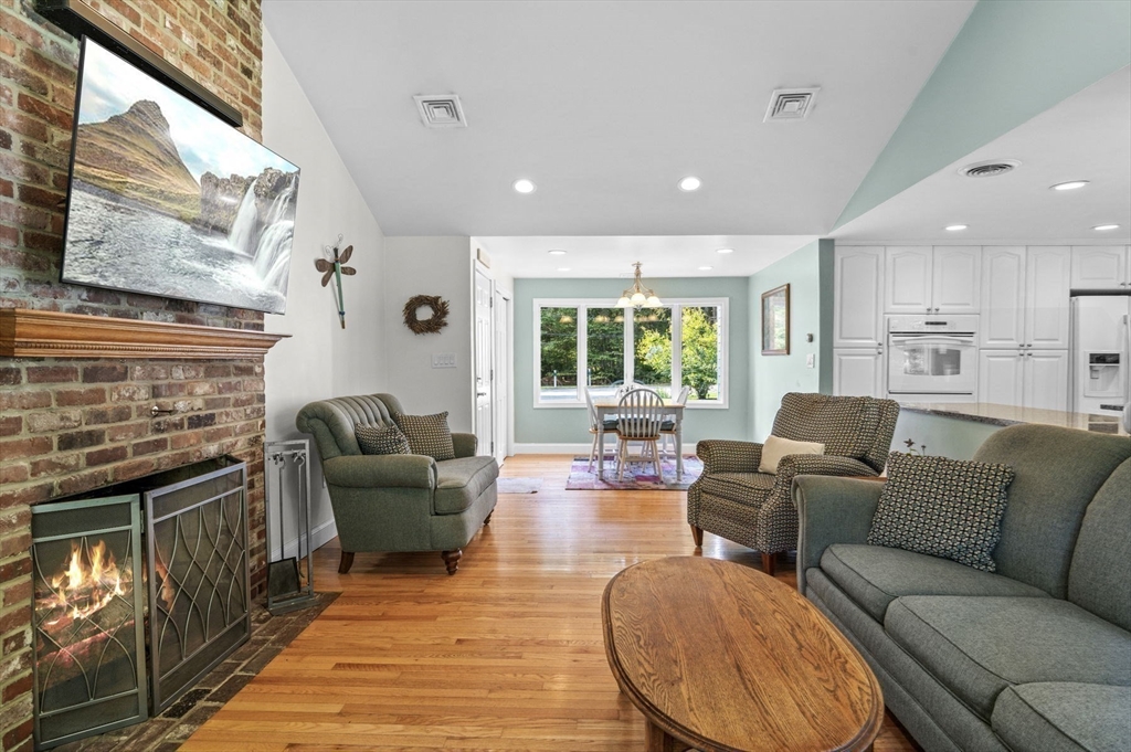 6 Beechwood Circle Boxford, MA 01921 - Photo 19 of 42 a living room with furniture a large window and a fireplace
