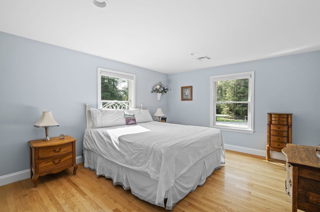 6 Beechwood Circle Boxford, MA 01921 - Photo 24 of 42 a bedroom with a bed and wooden floor