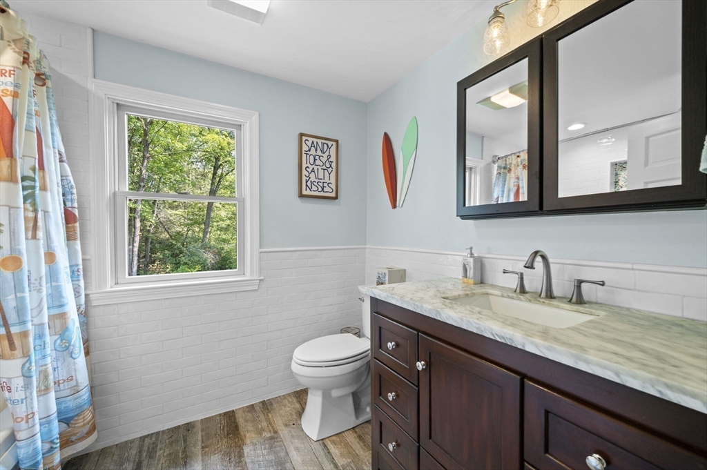 6 Beechwood Circle Boxford, MA 01921 - Photo 29 of 42 a bathroom with a granite countertop toilet sink and mirror