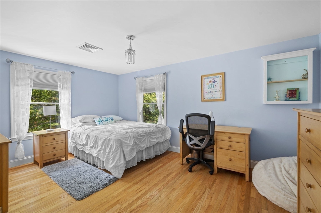 6 Beechwood Circle Boxford, MA 01921 - Photo 32 of 42 a bedroom with a bed and wooden floor