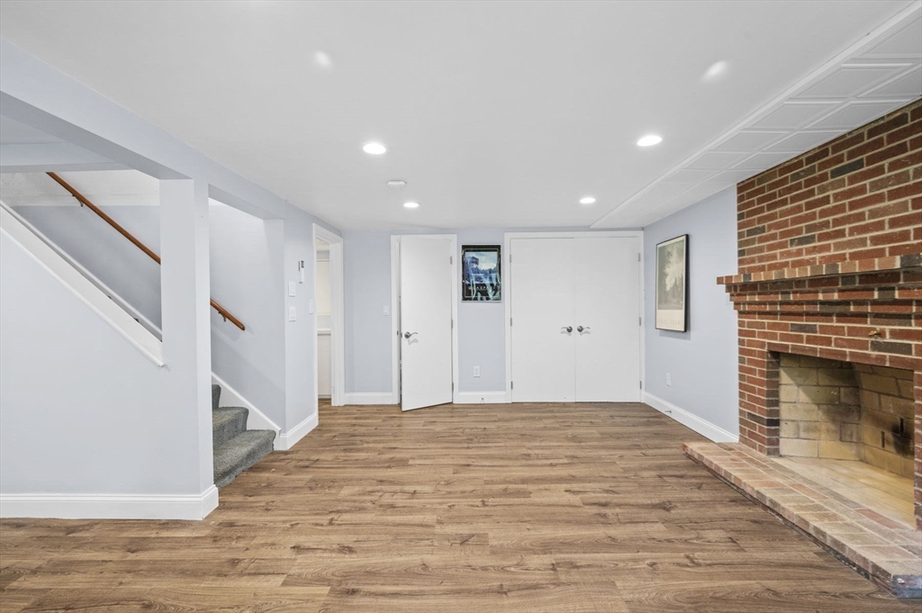 6 Beechwood Circle Boxford, MA 01921 - Photo 33 of 42 a view of an empty room with wooden floor and a fireplace