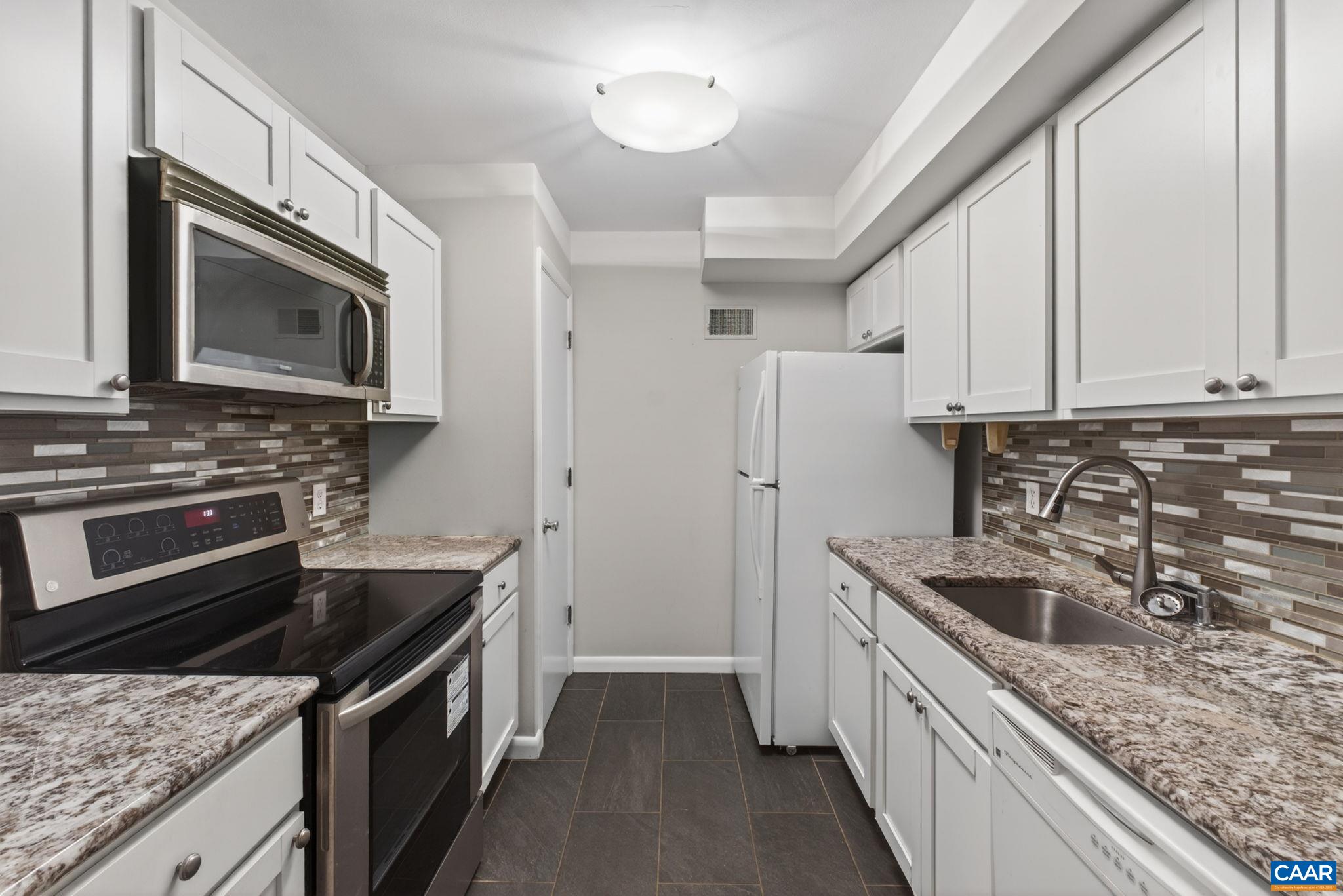 103 Turtle Creek Road, Unit 8 Charlottesville, VA 22901 - Photo 10 of 37 a kitchen with stainless steel appliances granite countertop a sink stove microwave and refrigerator