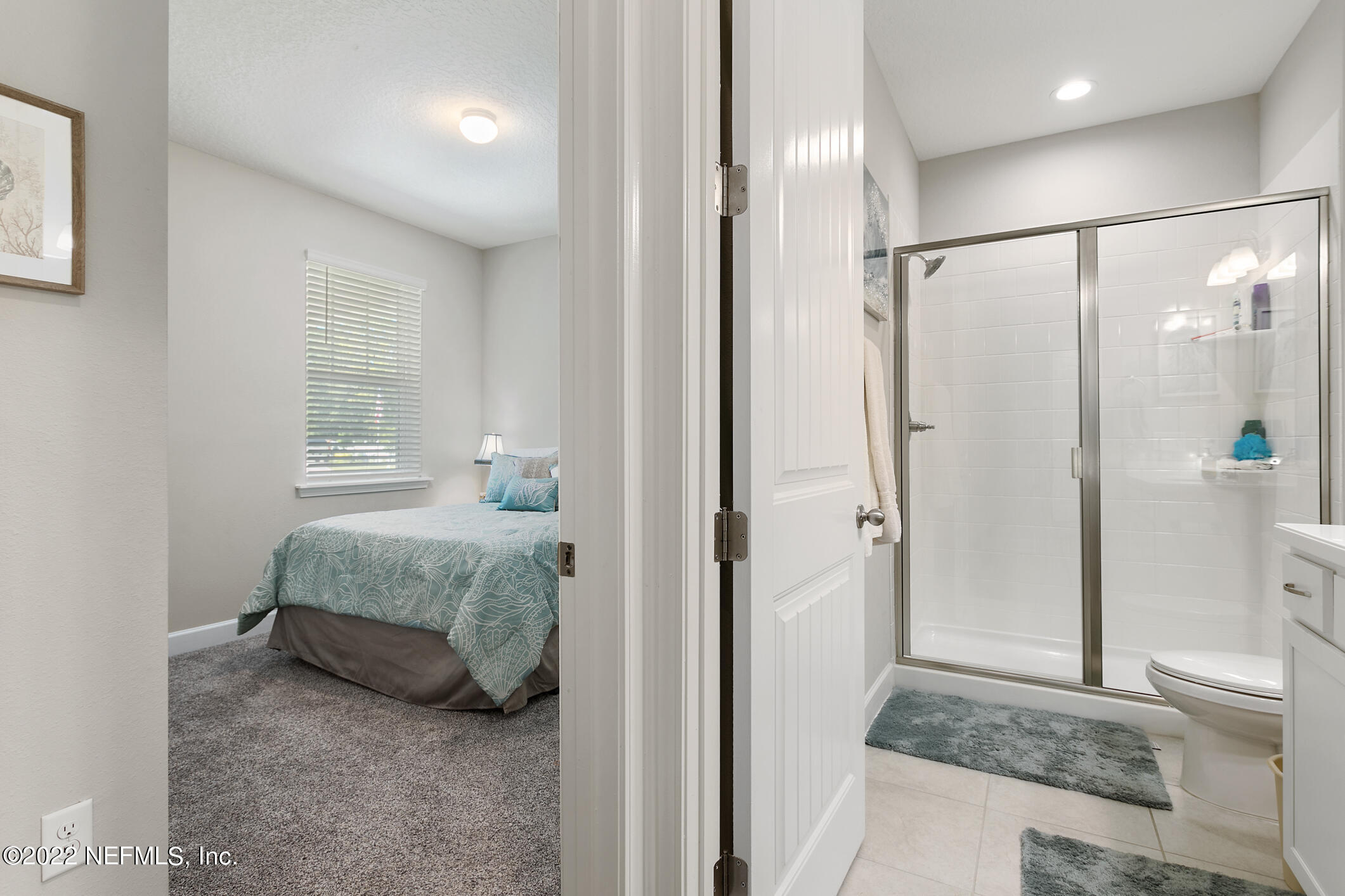 1098 Flach Drive St. Johns, FL 32259 - Photo 11 of 52 a en suite bathroom with a double vanity sink a mirror and a shower