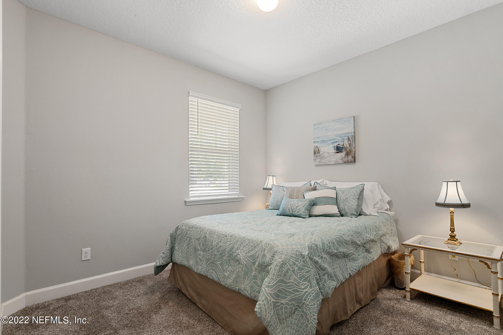 1098 Flach Drive St. Johns, FL 32259 - Photo 12 of 52 a bedroom with a bed and a lamp