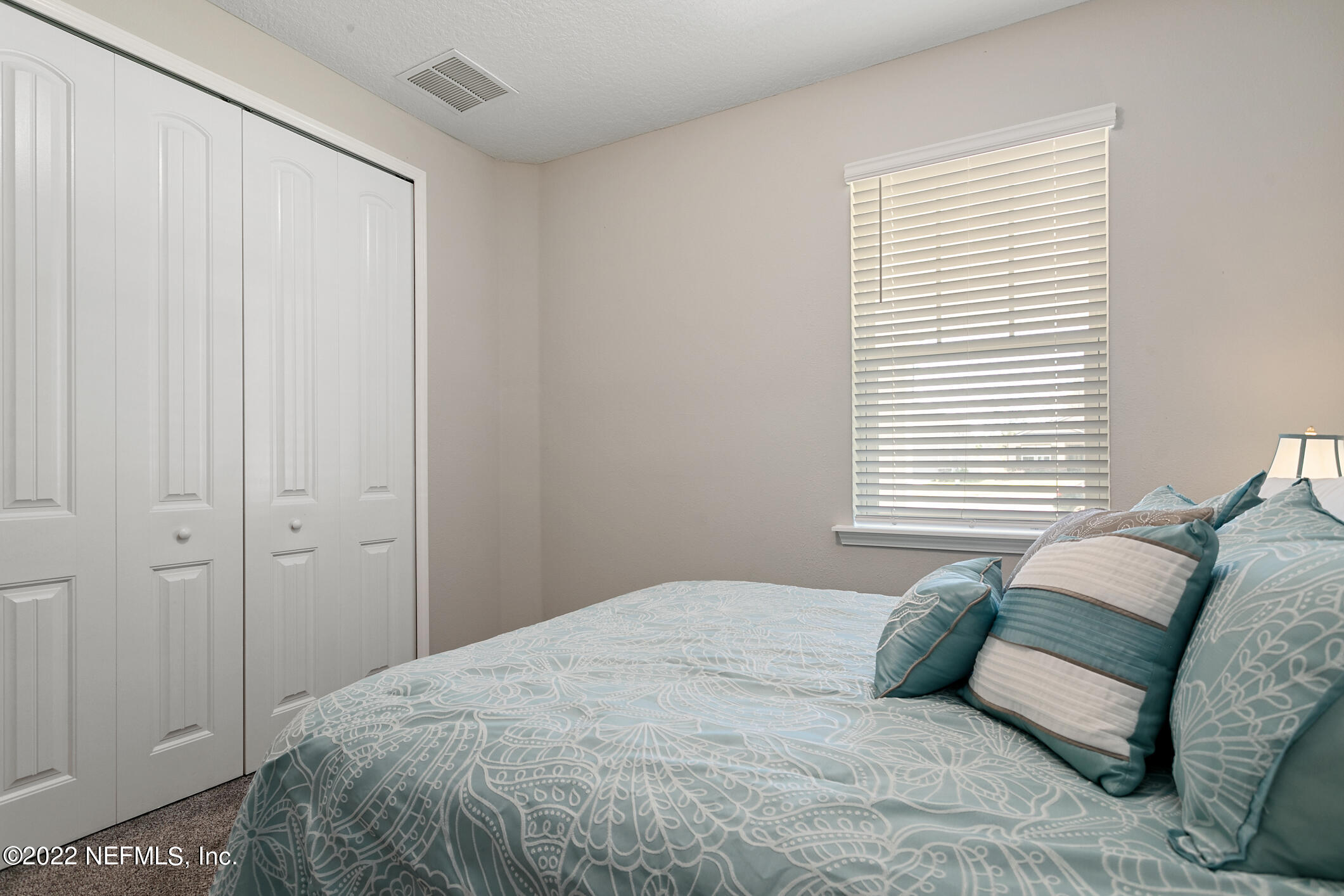 1098 Flach Drive St. Johns, FL 32259 - Photo 13 of 52 a bedroom with a large bed and a window