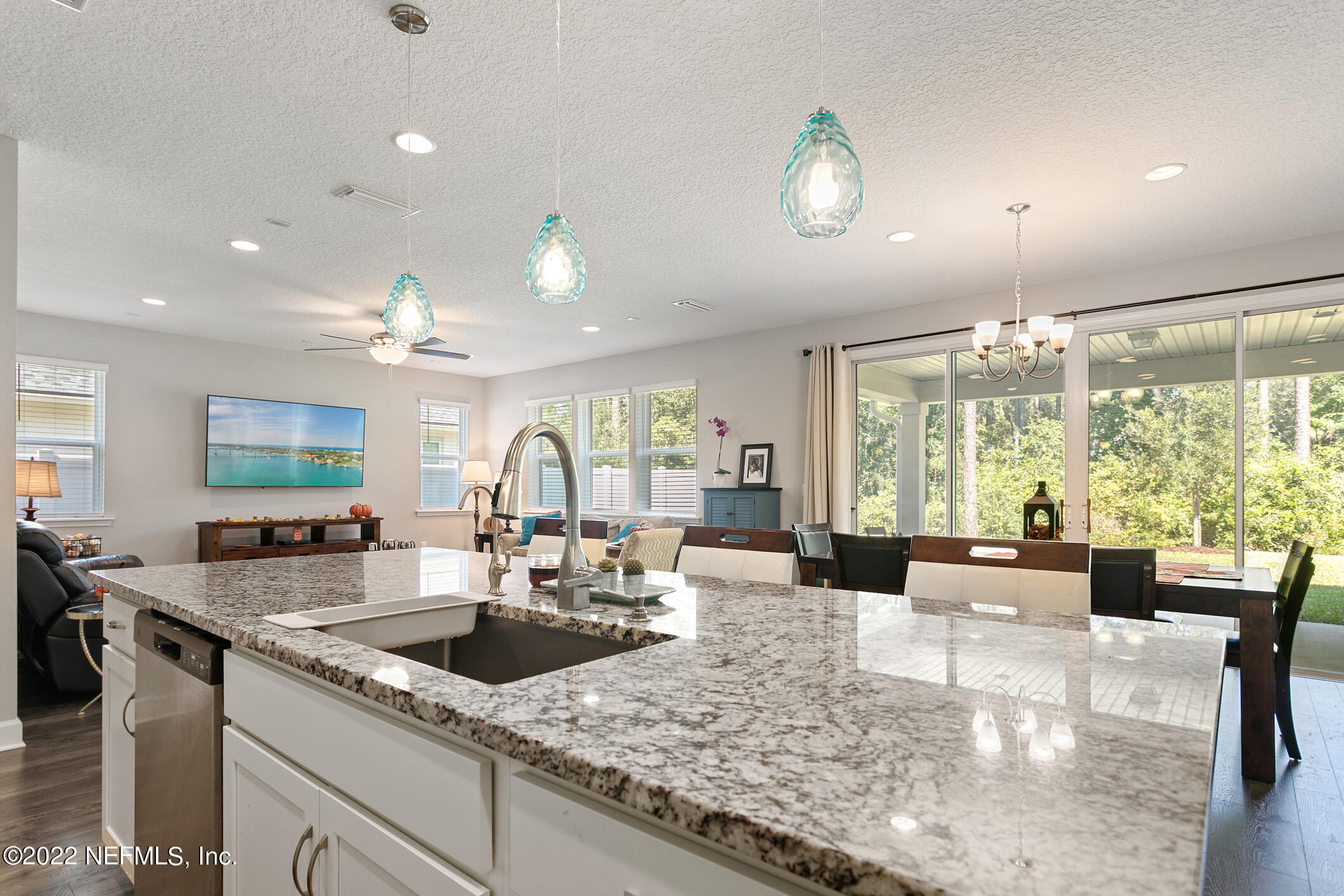 1098 Flach Drive St. Johns, FL 32259 - Photo 17 of 52 a kitchen with granite countertop a sink counter top space and living room view