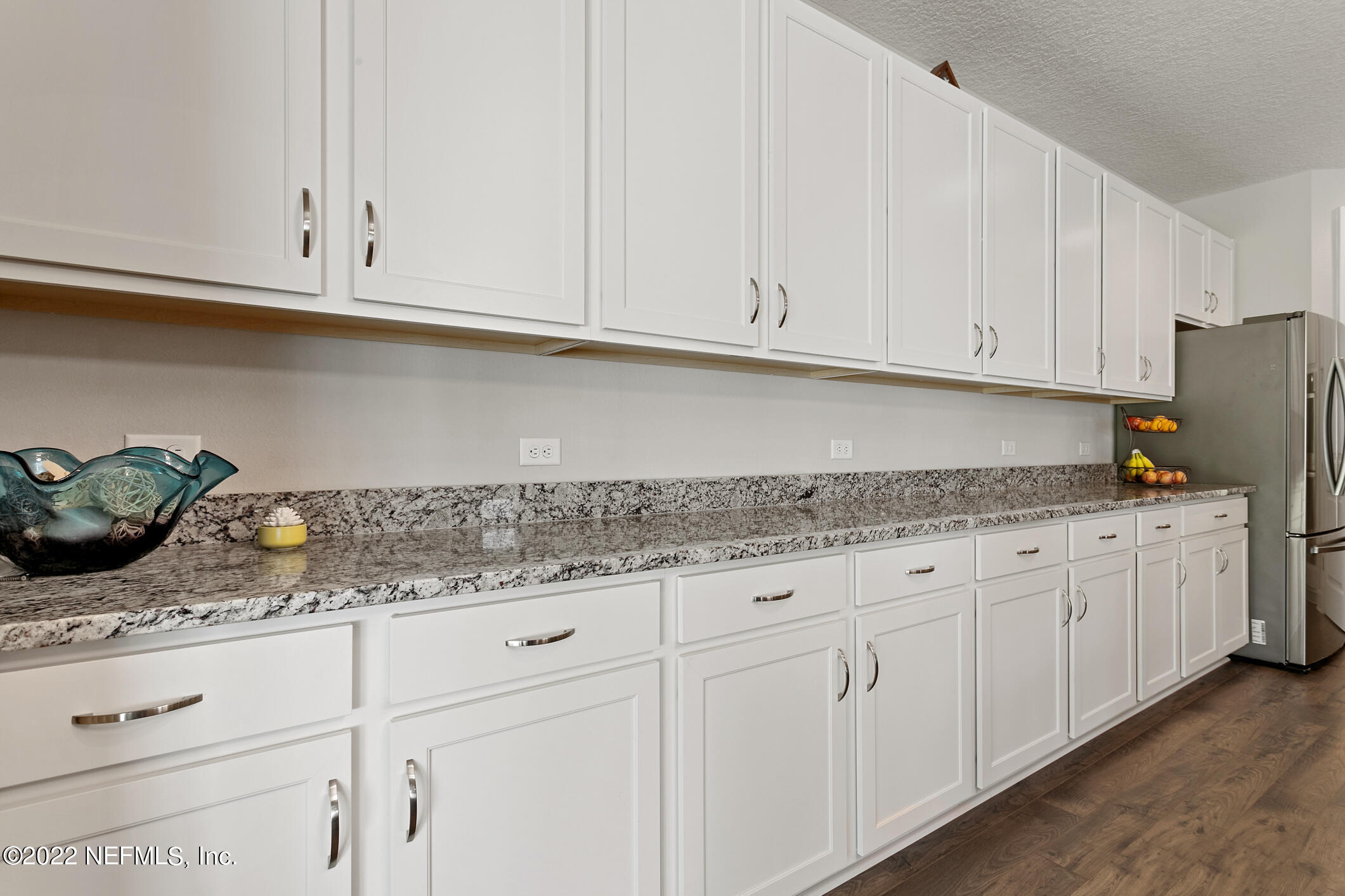 1098 Flach Drive St. Johns, FL 32259 - Photo 22 of 52 a kitchen with granite countertop white cabinets and a sink