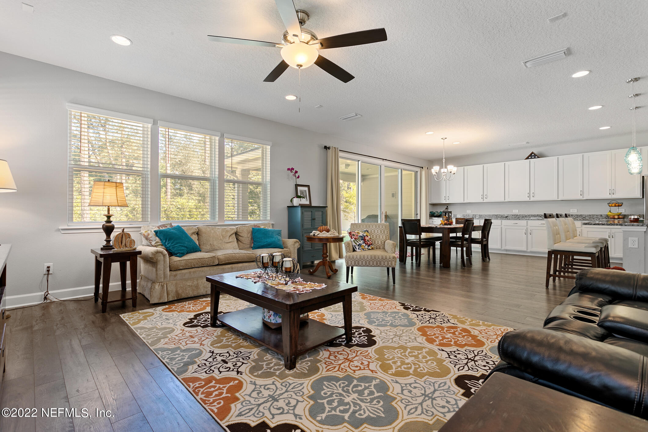 1098 Flach Drive St. Johns, FL 32259 - Photo 27 of 52 a living room with furniture kitchen view and a wooden floor