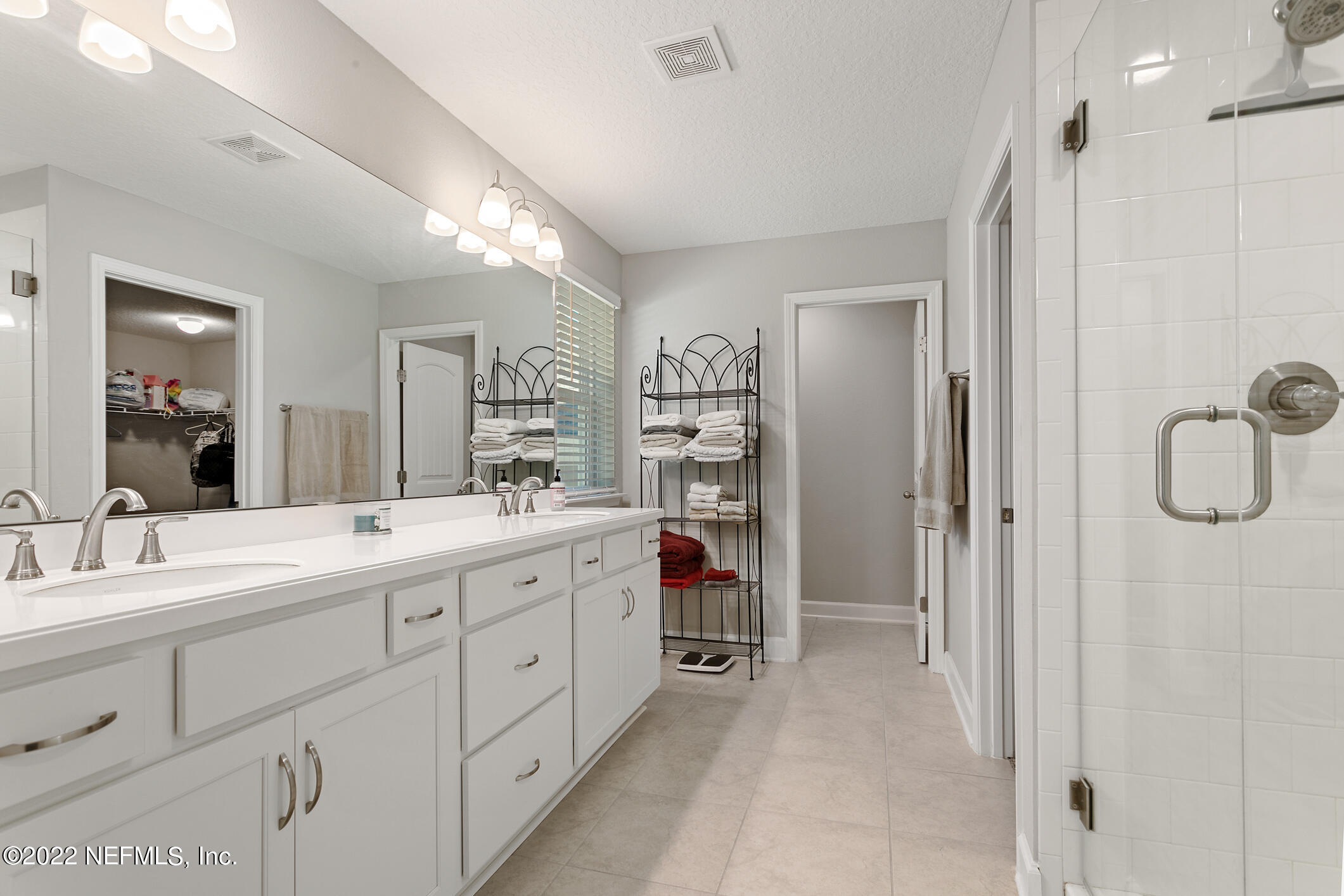 1098 Flach Drive St. Johns, FL 32259 - Photo 36 of 52 a spacious bathroom with a double vanity sink mirror and double