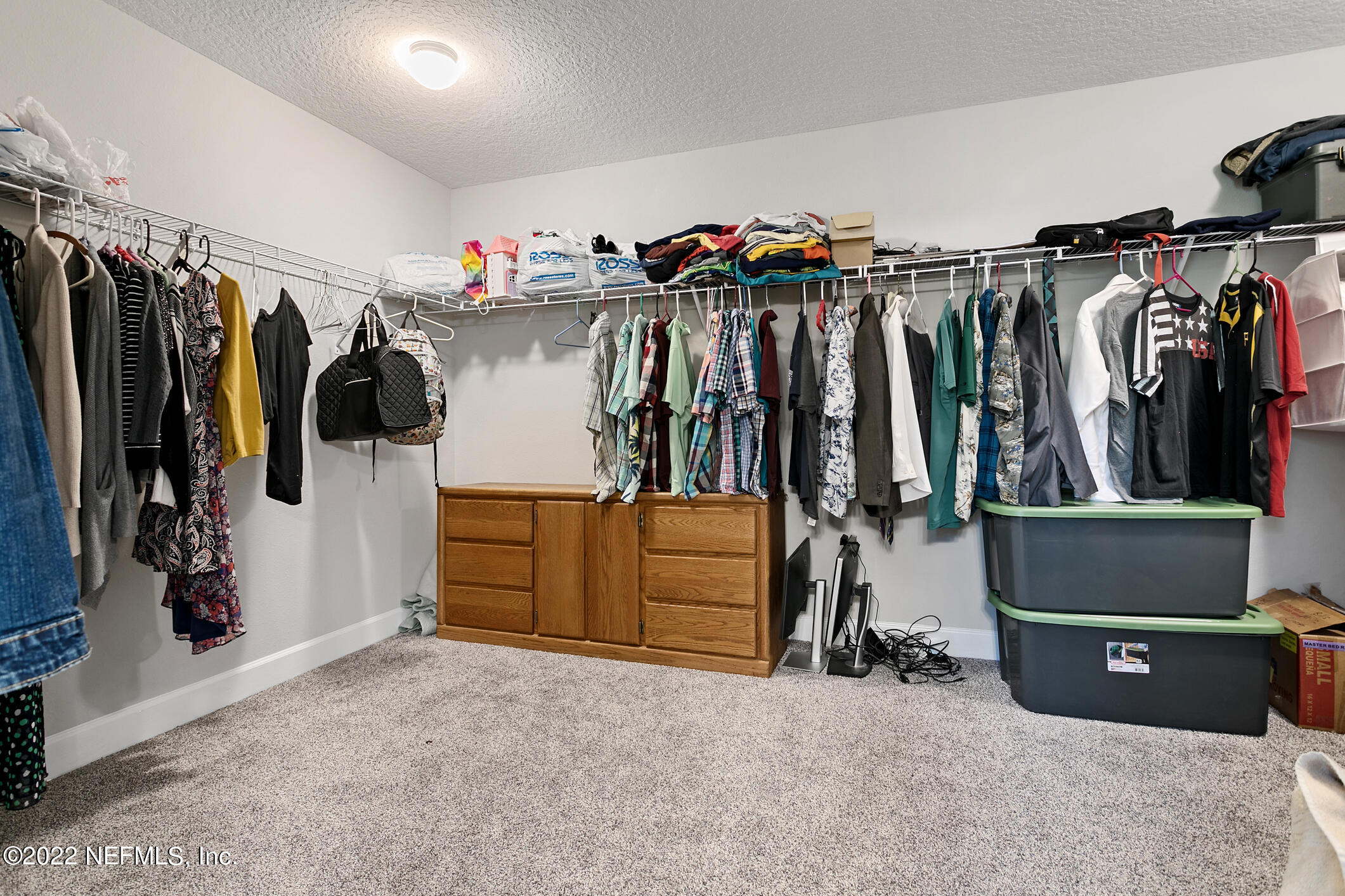 1098 Flach Drive St. Johns, FL 32259 - Photo 38 of 52 a view of walk in closet with clothes and shoes