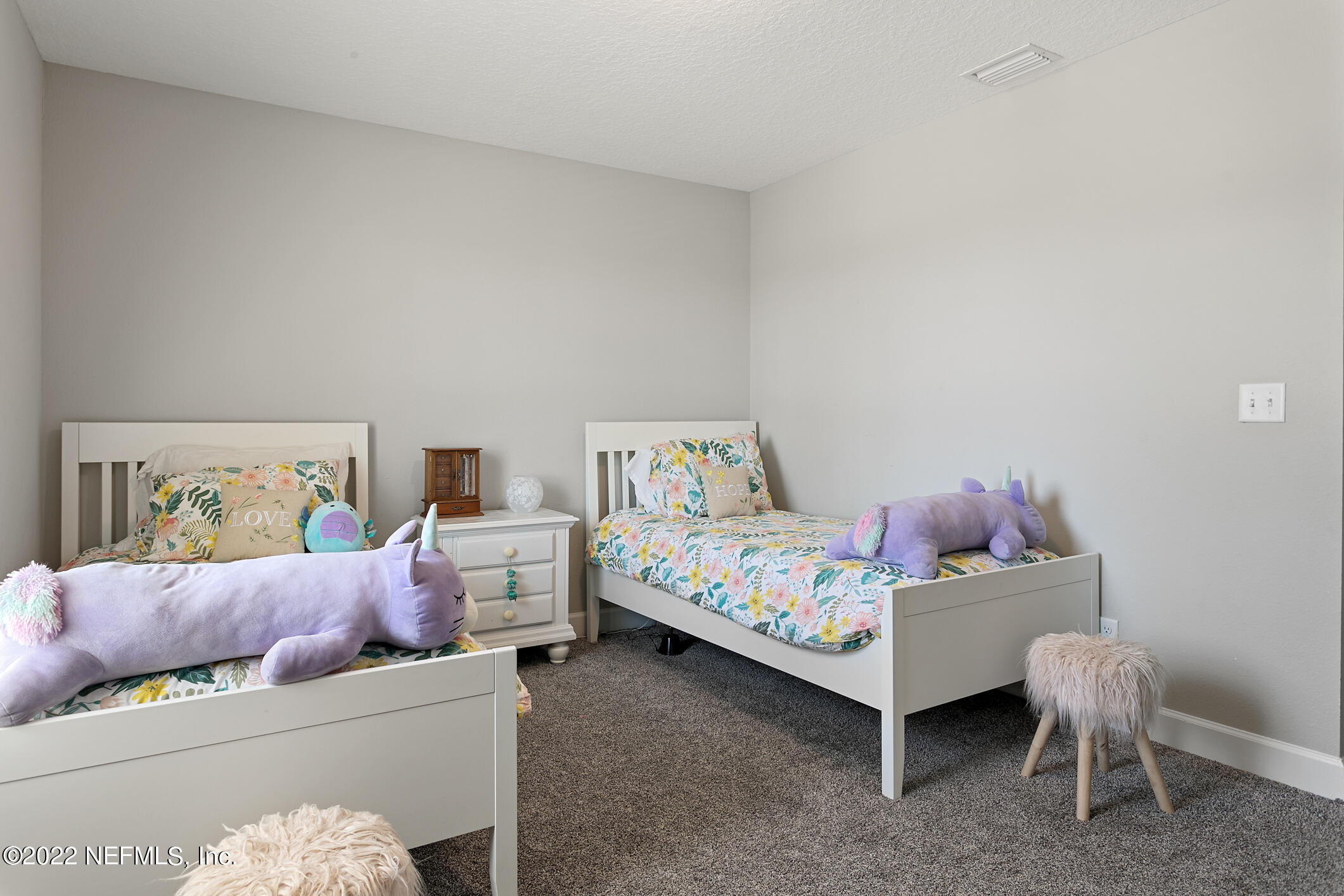 1098 Flach Drive St. Johns, FL 32259 - Photo 40 of 52 a bedroom with a bed and a couch