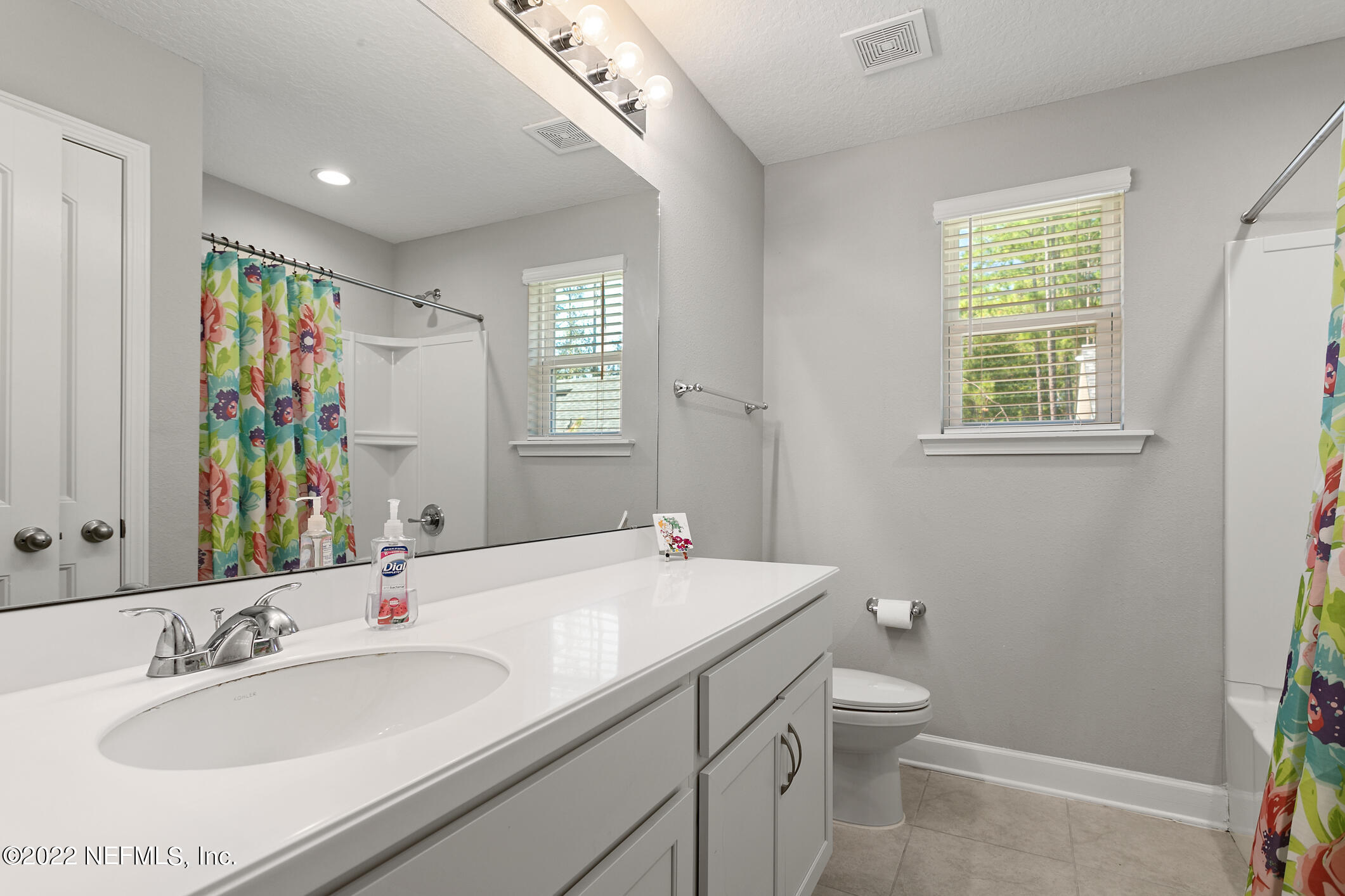 1098 Flach Drive St. Johns, FL 32259 - Photo 41 of 52 a bathroom with a sink a toilet and a mirror