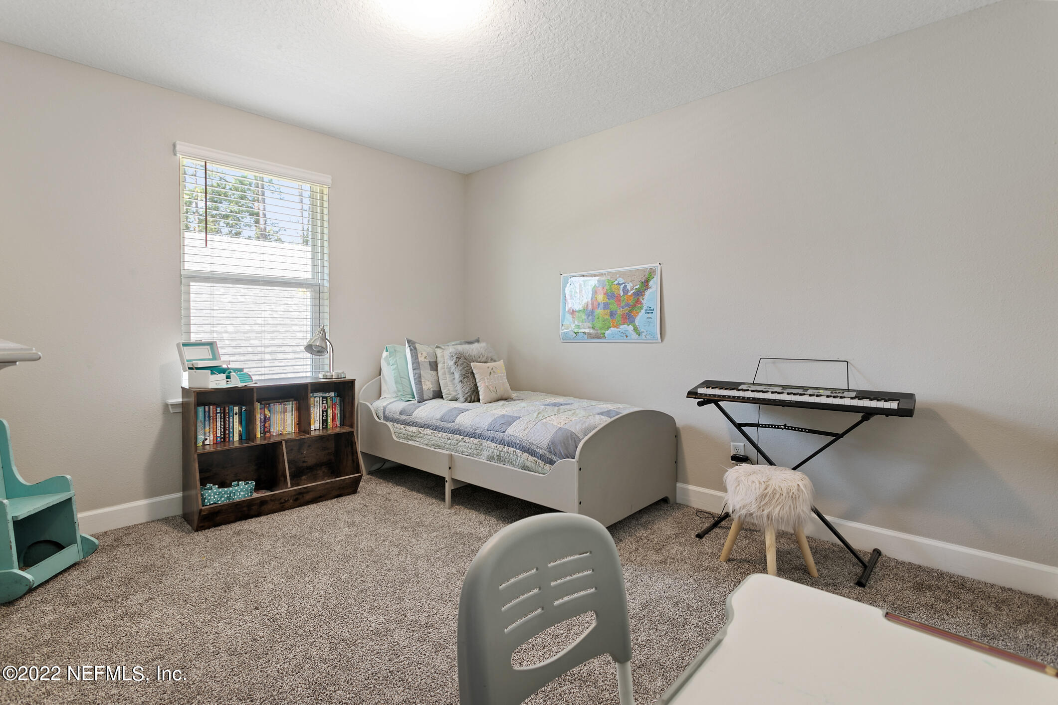 1098 Flach Drive St. Johns, FL 32259 - Photo 42 of 52 a bedroom with a bed and a window