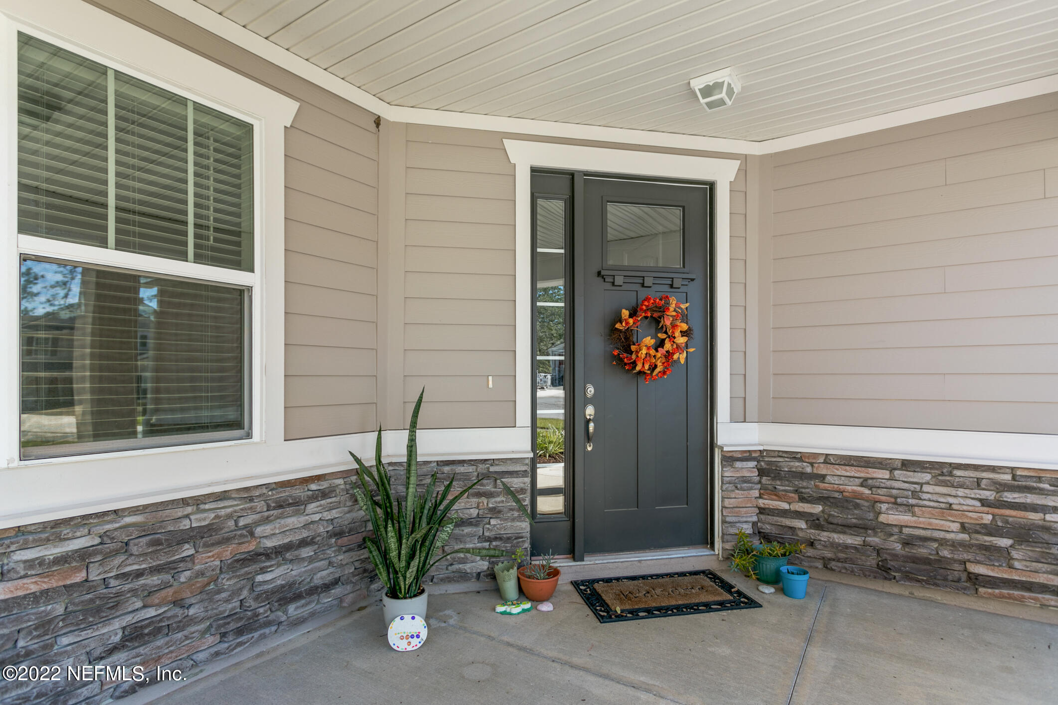 1098 Flach Drive St. Johns, FL 32259 - Photo 5 of 52 a potted plant sitting in front of a door