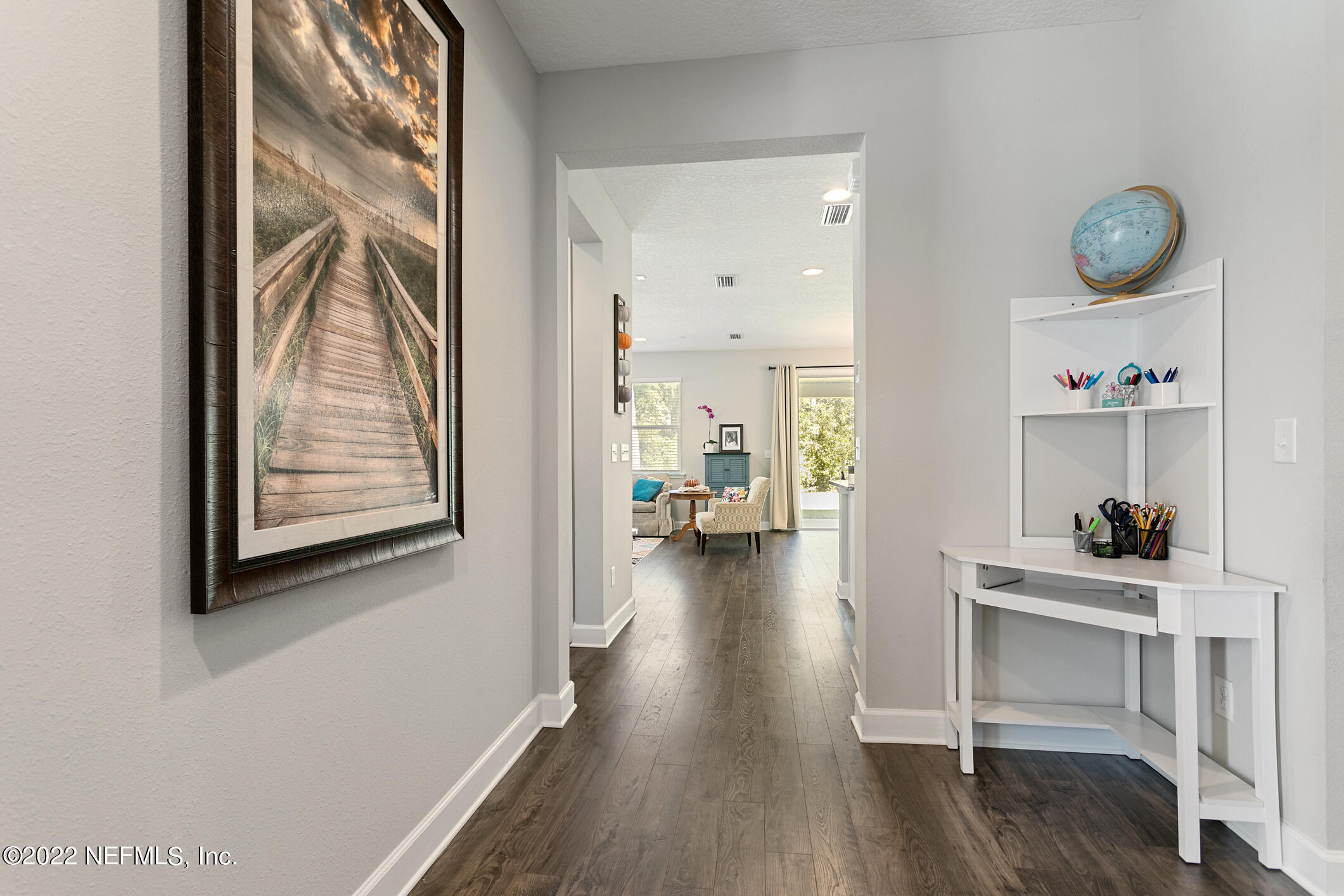 1098 Flach Drive St. Johns, FL 32259 - Photo 10 of 52 a view of a hallway and wooden floor with cabinet in living room
