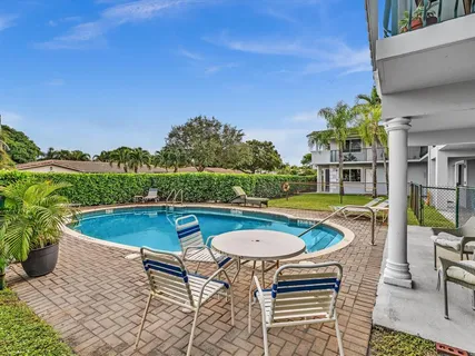 an outdoor space with swimming pool and furniture