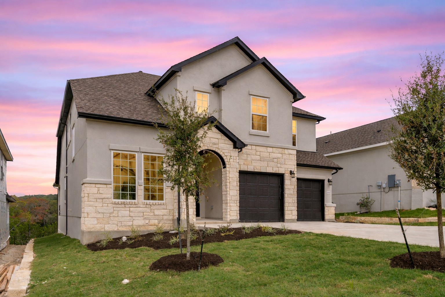 1045 Villa Rialto View Leander, TX 78641 - Photo 2 of 40 View of front of home featuring stone siding, concrete driveway, a front yard, and stucco siding