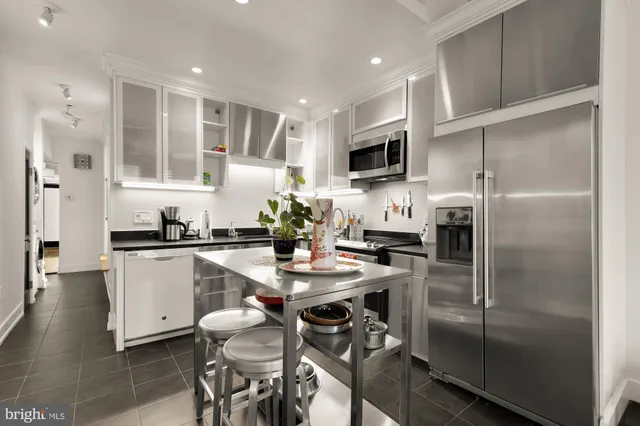 a kitchen with a refrigerator and a sink