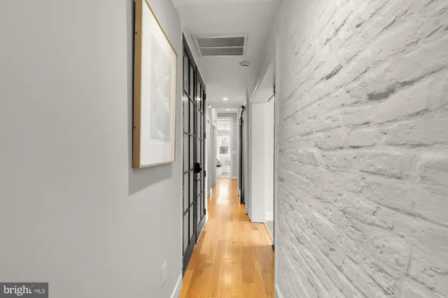 a view of a hallway with wooden floor