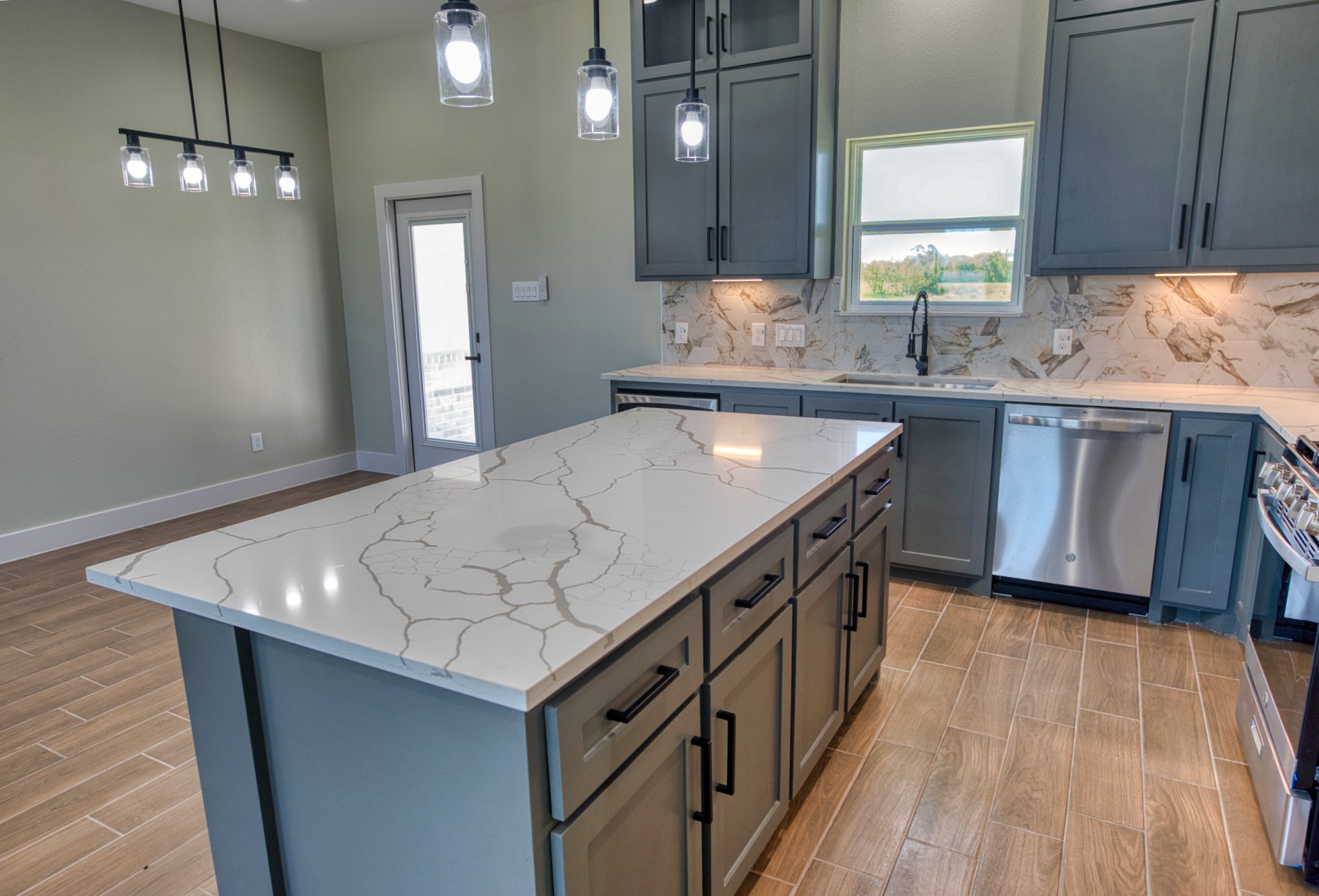 925 Buffalo Trail Angleton, TX 77515 - Photo 21 of 45 a kitchen with stainless steel appliances granite countertop a sink a stove and a wooden floors