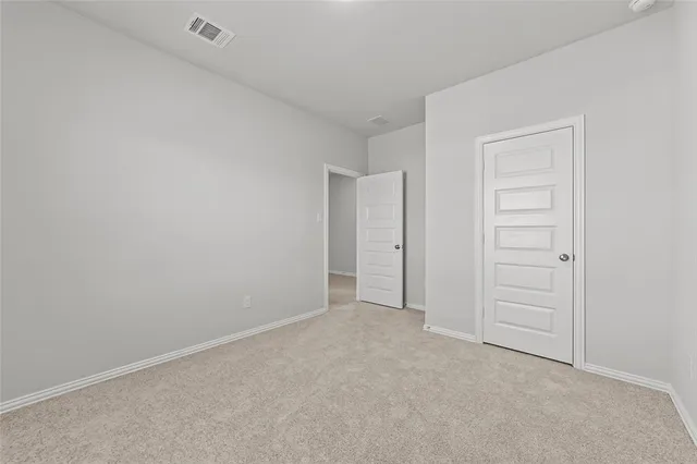 a view of an empty room and closet area