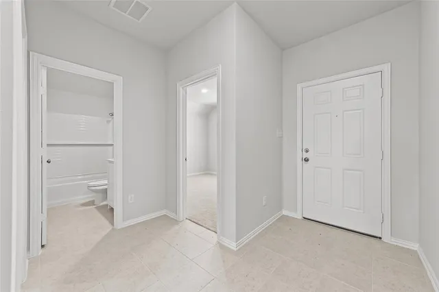 a view of an empty room and closet area