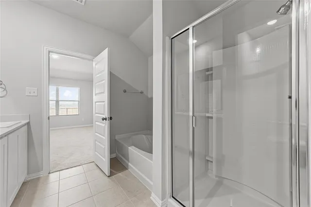 a bathroom with a shower and a glass door