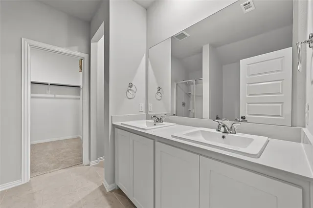 a bathroom with 2 sink and a mirror